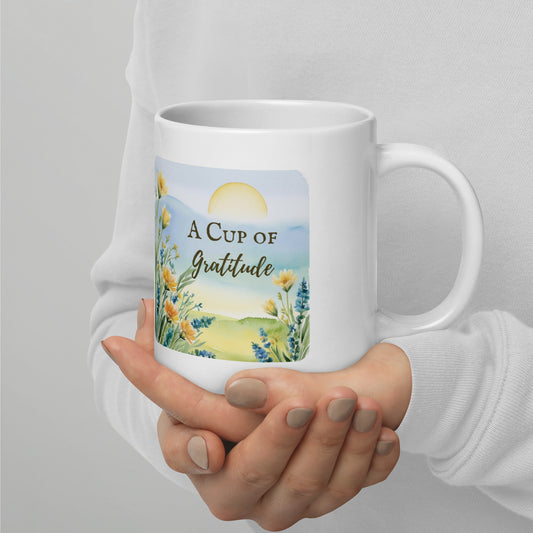 White ceramic mug with ‘A Cup of Gratitude’ in elegant script. 