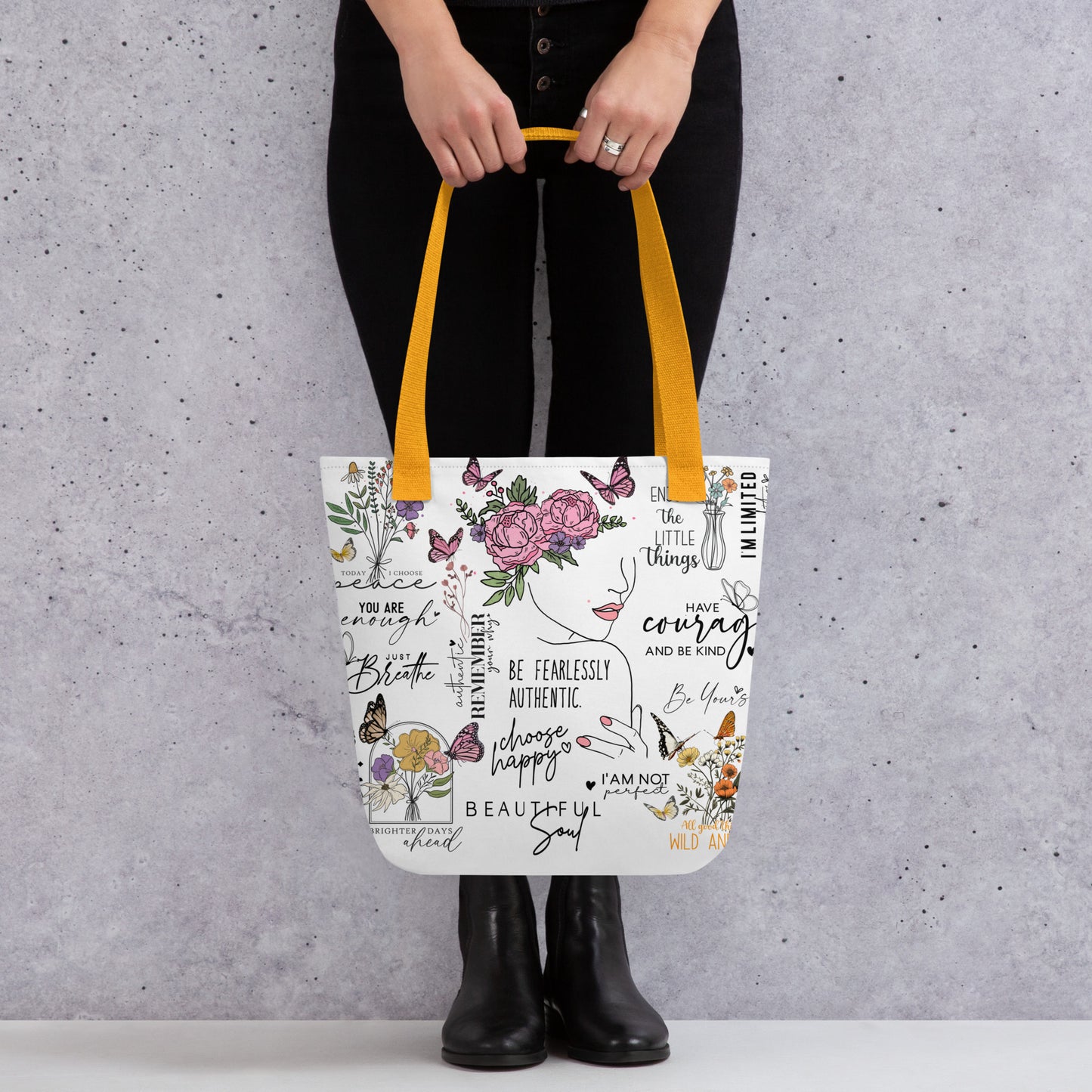 Stylish canvas tote bag featuring a collage of motivational quotes in bold, modern fonts, surrounded by soft floral accents. Uplifting phrases like “You got this”, “Keep going,” and “Be kind to yourself” are printed across the bag, creating and empowering and positive vibe. 