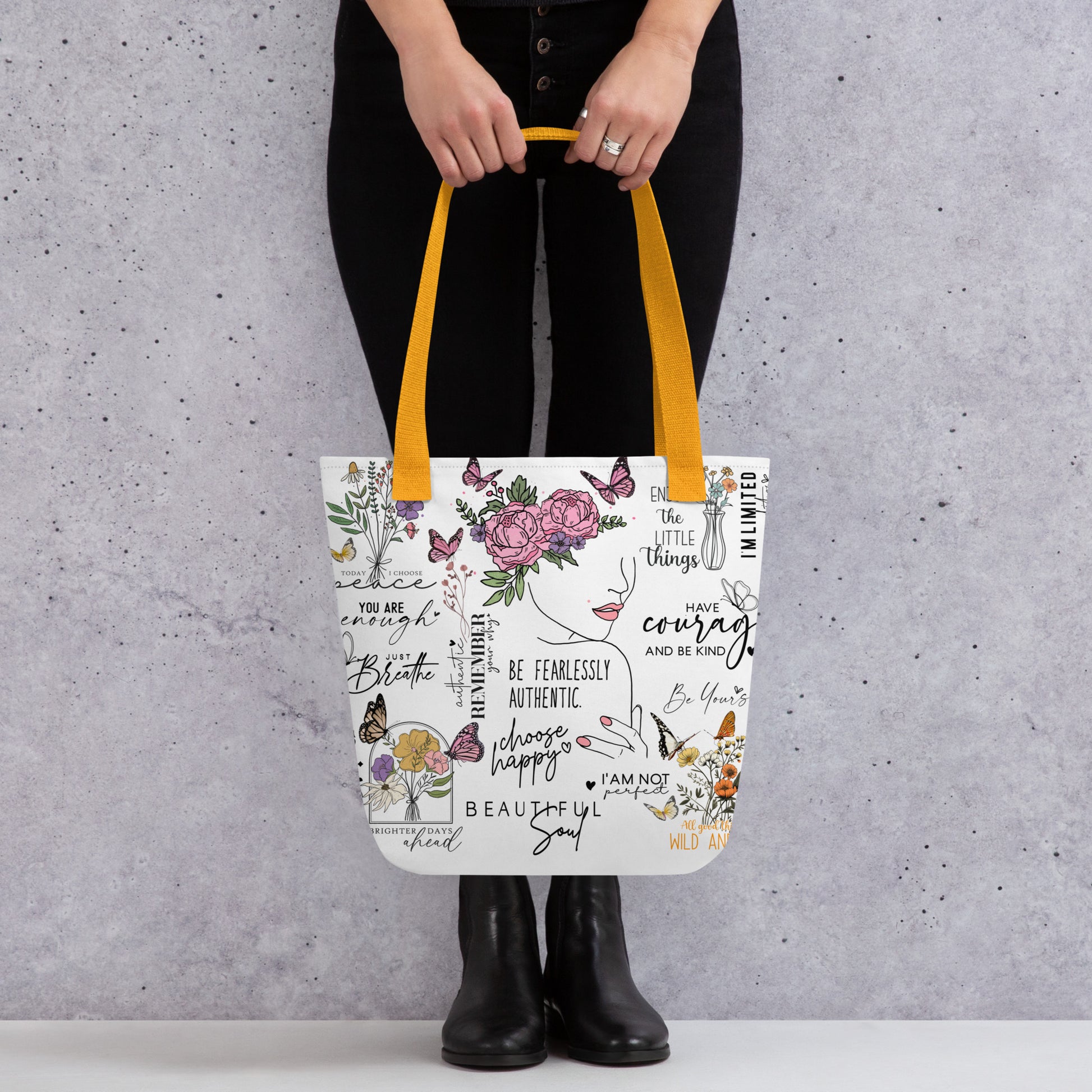 Stylish canvas tote bag featuring a collage of motivational quotes in bold, modern fonts, surrounded by soft floral accents. Uplifting phrases like “You got this”, “Keep going,” and “Be kind to yourself” are printed across the bag, creating and empowering and positive vibe. 