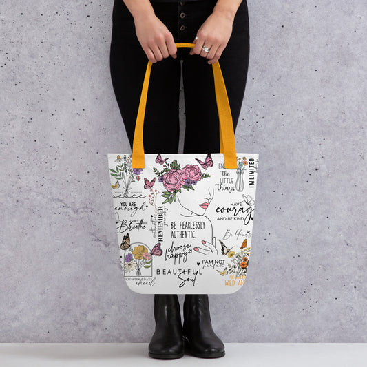 Stylish canvas tote bag featuring a collage of motivational quotes in bold, modern fonts, surrounded by soft floral accents. Uplifting phrases like “You got this”, “Keep going,” and “Be kind to yourself” are printed across the bag, creating and empowering and positive vibe. 