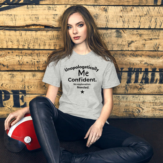Grey unisex T-shirt with bold text that says “Unapologetically Me Confident. No explanation Needed.” in black lettering 